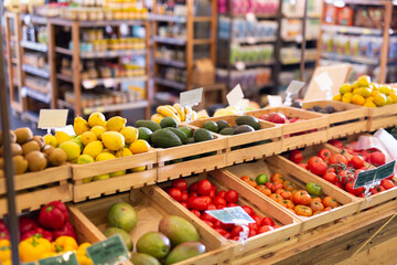 Showcase with fresh organic vegetables and fruits in supermarket