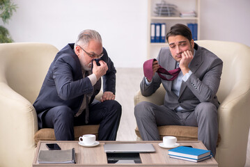 Two businessmen discussing project at workplace