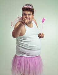 I've got something for you. An overweight man in a pink fairy costume pointing at the camera. - obrazy, fototapety, plakaty