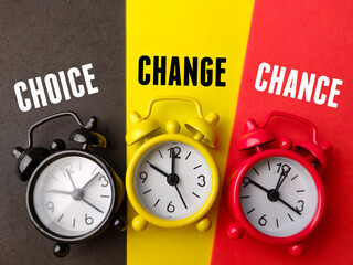 Top view alarm clock with text CHOICE CHANGE CHANCE on colorful background.