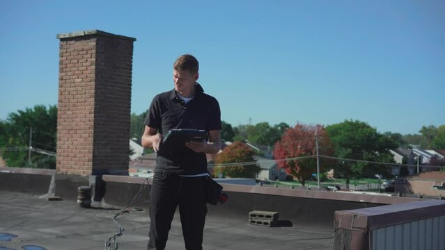 Roofing inspector performing a routine inspection on a low slope roof
