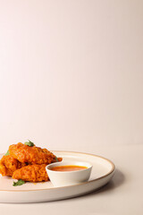 spicy buffalo wing on a plate served gourmet decorated with coriander leaves