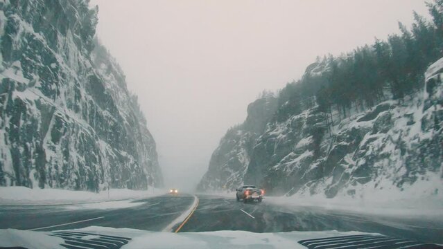 Driving in a winter storm in a canyon