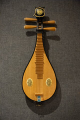 Antique Asian music instrument, pipa, hung in wall in a music studio