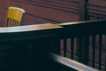 High angle view of wooden railing by chair in courtroom at Boston