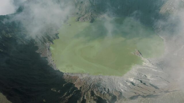 Aerial top down shot of active Chichonal Volcano with fog and sulfur water in the valley - Beautiful sunny day in Chiapas,Mexico