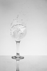 splash glass of gin and ice