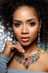 Beauty woman with a set of jewelry and afro hair. Beautiful girl in a necklace with a earrings,...