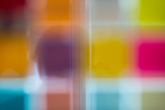 Defocused adhesive notes on glass wall at office