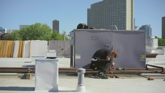 Inspector performing an HVAC unit inspection on a commercial building