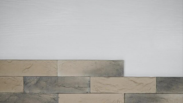 vintage brick background. artificial stone imitating neat brickwork. clinker tiles for home renovation. construction and facing materials. Stop motion.