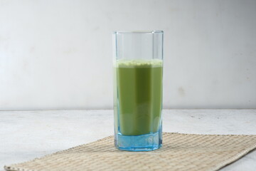 a glass of Japanese matcha latte, green tea with milk or soy milk, 
whitw background