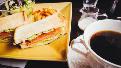 Sandwich with chicken, tomato, cucumber, grilled toast and coffee