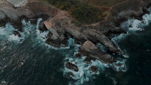 Bird's eye view of waves crashing the cliff on the Mazunte beach in Oaxaca, Mexico. View of Punta Cometa cliffs in the oaxacan coast.
