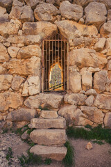 Portrait view, masonry work of barred tunnel at the Mycenae ruins Greece