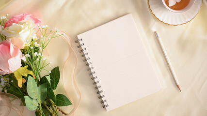 Empty notebook with pencil. Feminine workspace concept.