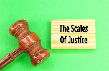 hammer a wooden hammer with a wooden board with the words the scales of justice