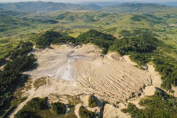 Aerial spectacular view over Muddy Volcanos in Romania at Paclele Mici during a summer morning