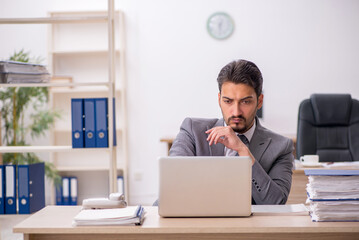 Young male employee working in the office