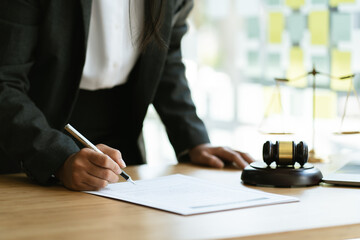 Judge gavel with Justice lawyers having team meeting at law firm in background. Concepts of law.