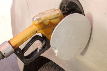 Gasoline pump refilling the automobile gasoline tank. Gasoline prices increasing. Petrol prices...