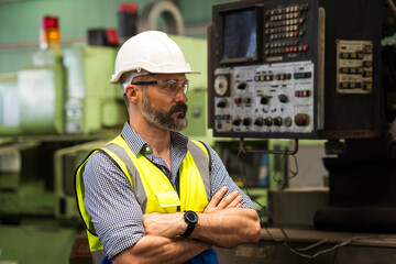 Handsome technician worker at manufactorying. Caucasian middle aged engineer manager wearing...