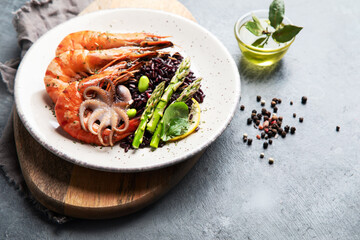 Shrimps with brown rice on light gray background.