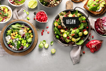 Vegan dishes assortment on gray background.