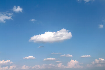 Close up clouds on vast bright blue sky background with breeze