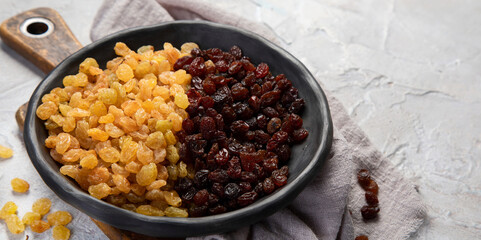 Golden and brown raisins on light  background. Dried Fruits. Top view, flat lay, copy space