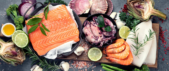 Fresh seafood arrangement on dark background.
