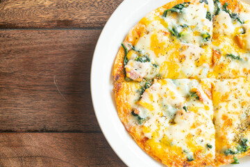 spinach and bacon pizza on plate