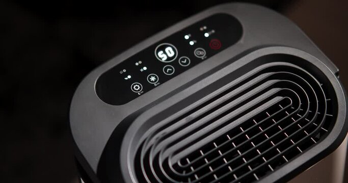 Person Turn On The Portable Dehumidifier, a Device That Removes Excess Moisture From The Air. - high angle