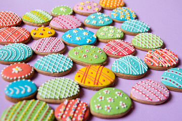 Fototapeta na wymiar Happy Easter background. Multicolored pastel easter eggs cookies. Easter greeting card with colorful gingerbread.Mock up. Banner. Top view.