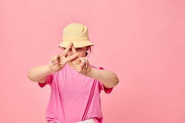 portrait of a young woman in a pink T-shirt and hat Youth fashion
