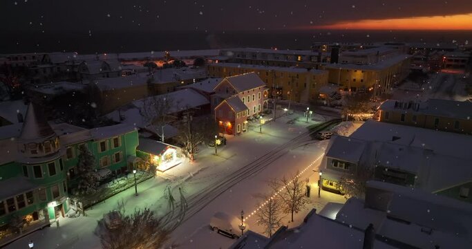 Victorian Homes And Buildings Decorated For Christmas During Winter Snowfall And Sunset. Cape May, New Jersey