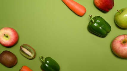 Healthy food concept. Fresh vegetables and fruits with on green background.