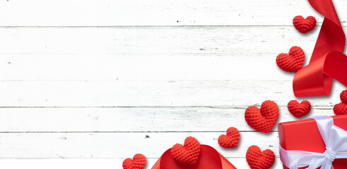 Red hearts and ribbons on white wooden background. Valentine's Day, Anniversary, and Birthday Concepts