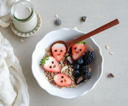 Healthy homemade breakfast snacks. Muesli Breakfast Bowl with Berries. Delicious wholesome breakfast meal with fresh fruits and nuts for your day's energy requirements.