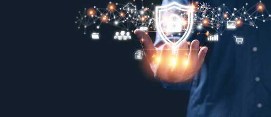 Businessman holding shield with padlock icon protection personal data in a virtual world on hands. Cybersecurity protection, technology, insurance business, business network security concept.