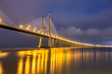 The famous cable-stayed Vasco da Gama bridge across the river Tagus in Lisbon, Portugal, at night