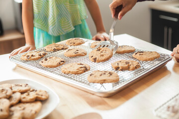 Mother and daughter baking cookies in a bright kitchen