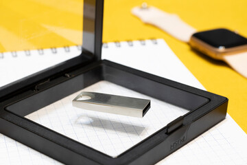 Close-up of a new flash drive in a box, the concept of memory and new technologies.