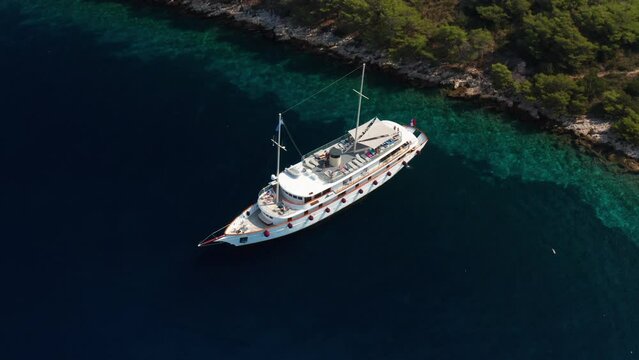Scenic View Of Luxury Ship Floating In Adriatic Sea Near Paklinski Islands In Hvar, Croatia. Aerial Pullback