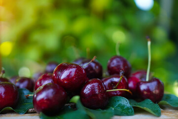Ripe fresh cherries on a wooden background