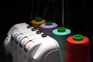 close-up Professional overlock sewing machine with multicolored thread