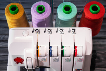 close-up Professional overlock sewing machine with multicolored thread. thread tension setting. View from aboveiew from above
