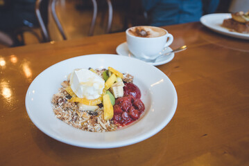 Granola with fruit, flat white