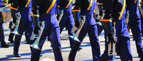 Marching band in a parade outdoors.