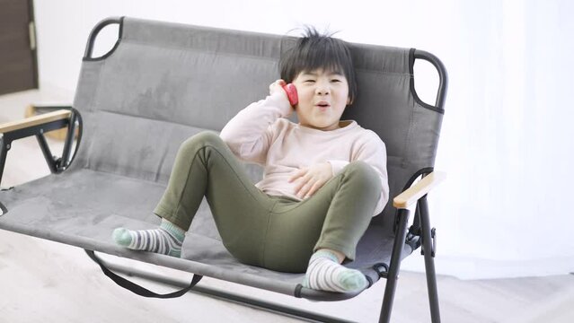 電話で会話をするアジア人の幼児